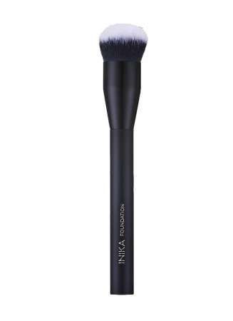 INIKA Foundation makeup brush with a simple black handle and dense rounded bristles fading from dark graphite to white tips.