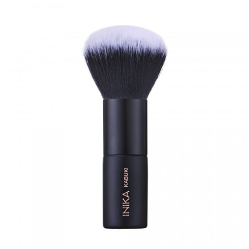 INIKA Organic Kabuki makeup brush with a short black handle, brand logo and dense rounded bristles fading from black to white tips.