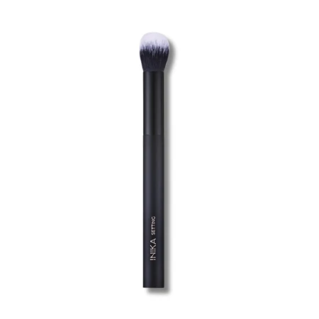 INIKA Organic Setting Brush with a slim black handle marked INIKA SETTING and dense soft ombre bristles from dark base to white tips.
