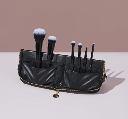 Set of seven INIKA Organic brushes in an elegant black case, with black handles and soft two-tone bristles.