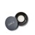 Round INIKA container with a black lid marked INIKA and a light loose or pressed powder inside.
