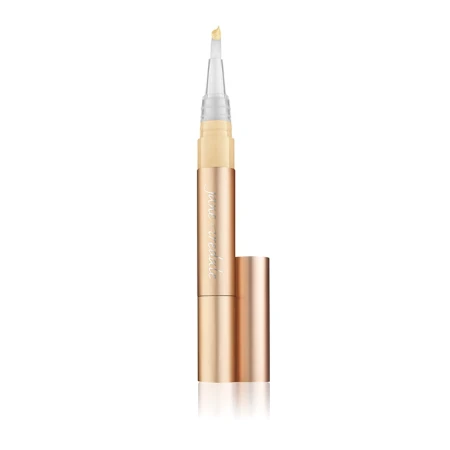 Single Jane Iredale Active Light concealer pen with brush applicator in elegant gold packaging.