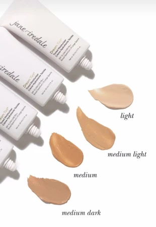 Four Dream Tint Tinted Moisturizer tubes laid sideways with shade samples flowing from each tube.