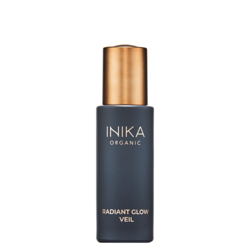 INIKA Organic Radiant Glow Veil in an elegant dark matte glass bottle with a metallic gold cap.
