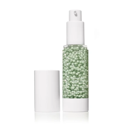 White pump serum bottle with cap removed, showing green spheres suspended in a gel base inside the clear center.