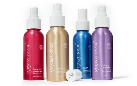 Four Jane Iredale hydration setting sprays shown side by side: POMMISST, BALANCE, D2O and Lavender.