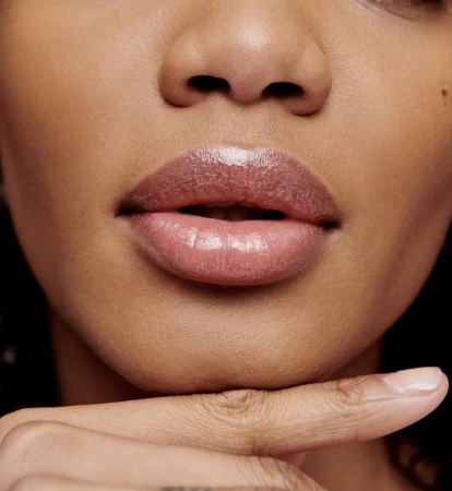 Jane Iredale lip gloss in a subtle natural shade with a satin glossy finish.