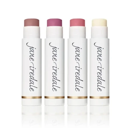 Four Jane Iredale Lip Drink SPF 15 lip balm sticks in white packaging with gold accents.