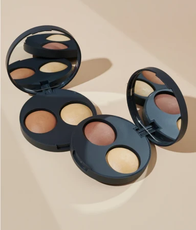 Two open INIKA Organic Baked Contour Duo compacts in different shades, each with a darker contour shade and lighter highlighter.