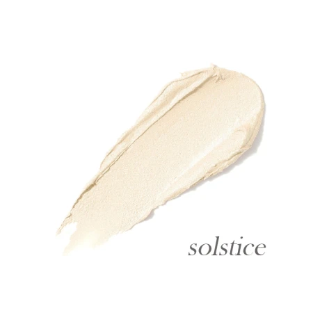 Solstice shade swatch in a light champagne tone with soft golden glow.