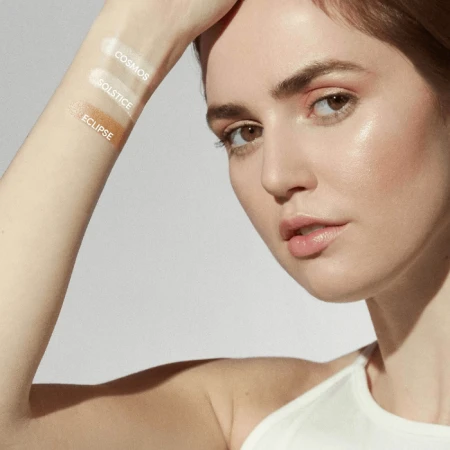 Cosmos, Solstice and Eclipse highlighter swatches on a forearm.