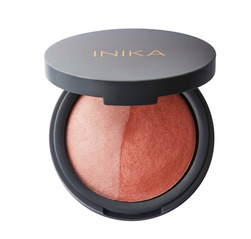 Open round INIKA Organic compact with baked blush duo in two shades, one lighter and one more intense brick-peach tone.