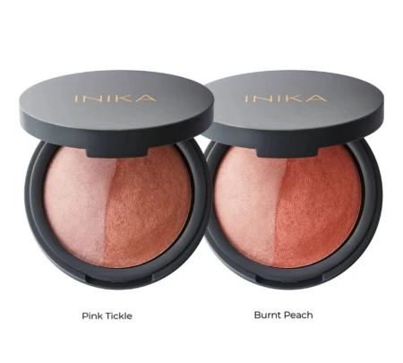 Two INIKA Organic baked blush duo compacts shown open, each divided into two shades.
