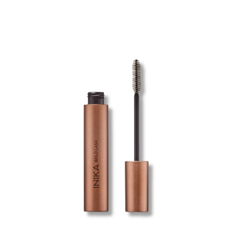 INIKA Organic Bold Lash Mascara in metallic copper-gold packaging with the applicator brush exposed.