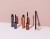 Four INIKA Organic eye makeup products displayed on a pale pink background.