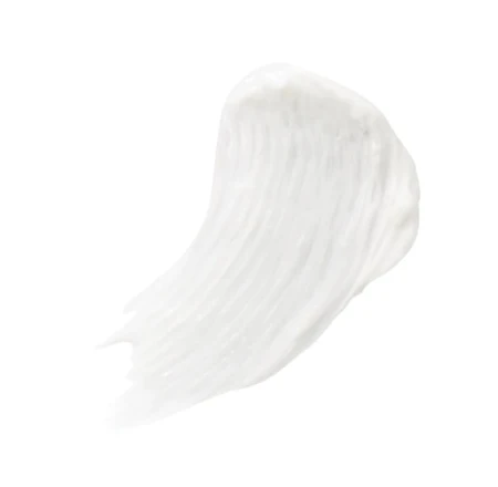 White creamy texture sample of PureLash Conditioner on a light surface.