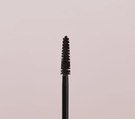 Close-up of a tapered mascara brush designed to separate and lengthen lashes.