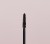 Close-up of a tapered mascara brush designed to separate and lengthen lashes.