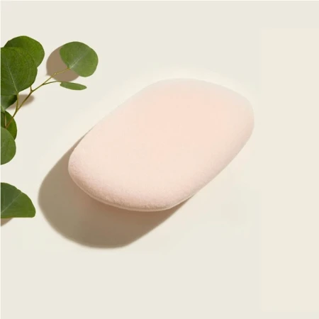 Pale pink latex-free makeup sponge with curved shape for precise foundation and powder application.