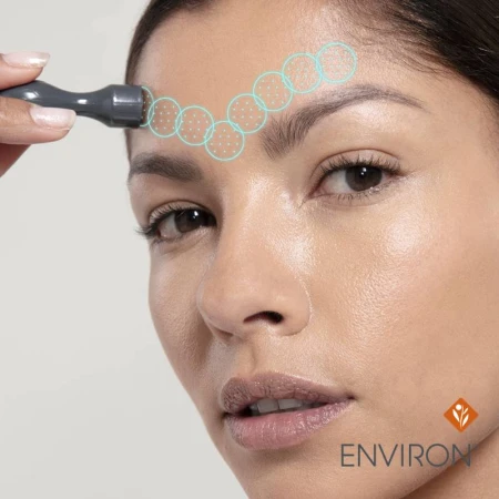 Woman using Focus-CIT on the forehead with graphic movement marks.