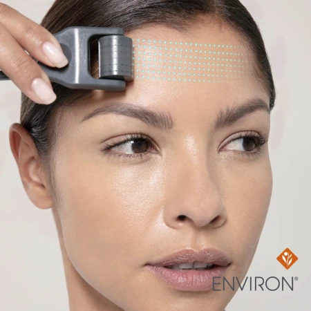 Woman using Cosmetic Roll-CIT on the forehead with movement guide marks.