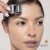 Woman using Cosmetic Roll-CIT on the forehead with movement guide marks.