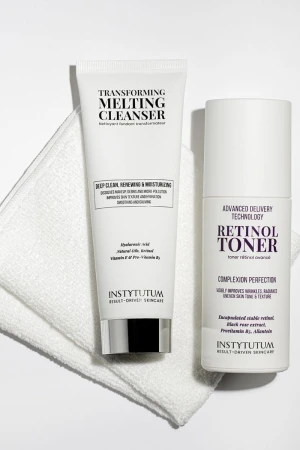 INSTYTUTUM Retinol Toner displayed with Transforming Melting Cleanser on a white towel.