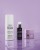 Three INSTYTUTUM skincare products on a purple reflective background with water droplets.