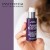 Hand holding purple INSTYTUTUM Superpacked X-Strength Retinol serum with white pump and silver cap.