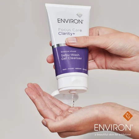 Hands squeezing clear ENVIRON Sebu-Wash Gel from the tube into the palm.