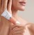 Close-up of hands holding an ENVIRON C-Boost Mela-Even Cream tube.