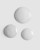 Close-up of three slightly milky gel droplets on a smooth grey background.