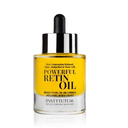 Glass dropper bottle with yellow INSTYTUTUM Powerful Retin Oil and label highlighting retinoid, algae, bakuchiol and stem cells.
