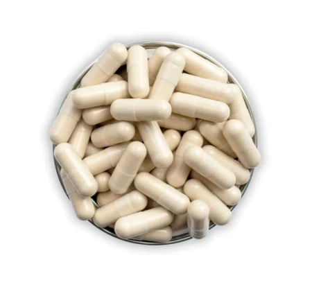 Open supplement tin with visible beige capsules arranged in layers.