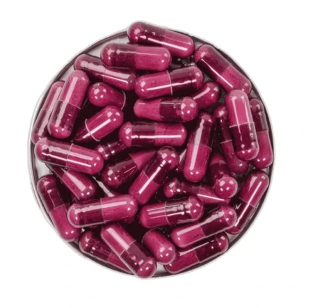 Open tin filled with transparent purple Skin Antioxidant capsules containing powder.
