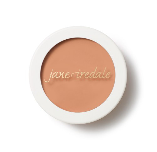 Jane Iredale Enlighten Concealer cream concealer in a round compact with a white lid and gold jane iredale logo, in a warm beige-peach shade.