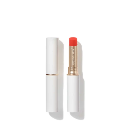 Jane Iredale Just Kissed Lip and Cheek Stain stick in white and gold packaging with a vivid red-orange tint.