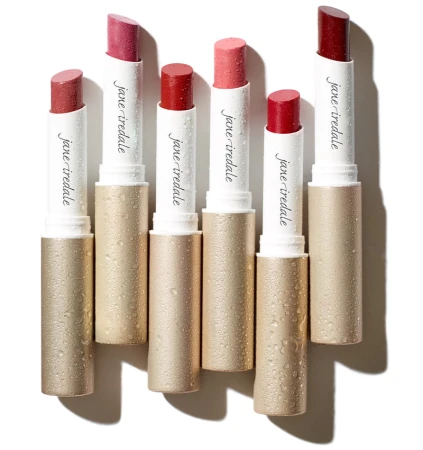 Jane Iredale ColorLuxe lipstick collection in elegant gold packaging with water droplets on the bullets.
