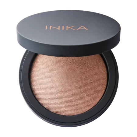 INIKA Organic Baked Illuminisor STARLIGHT in an open black compact with gold INIKA logo.