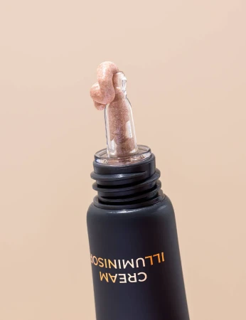 INIKA Organic Cream Illuminisor PINK PEARL with applicator showing a glossy pink-gold cream.
