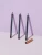 Three INIKA Organic Eye Pencil shades standing upright with a gold cap on a pale background.