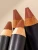 Close-up of several INIKA Organic Lip Crayon tips showing beige, nude and brown tones.