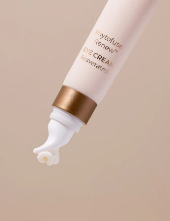 Close-up of the INIKA Organic Phytofuse Renew Eye Cream tube tip with white massage applicator.