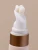 Cream emerging from the curved white applicator tip of INIKA Organic Phytofuse Renew Eye Cream.