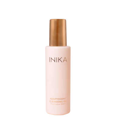 INIKA Organic Adaptogenic Cleansing Oil bottle in soft pink matte packaging with gold applicator.