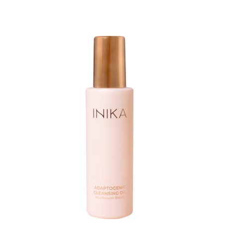 INIKA Organic Adaptogenic Cleansing Oil bottle in soft pink matte packaging with gold applicator.