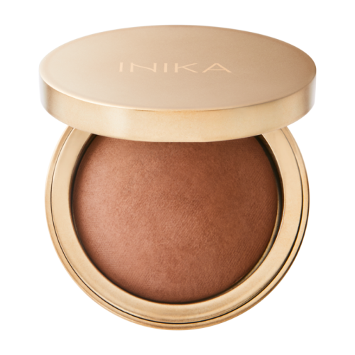 Open satin-gold INIKA Organic compact showing the warm SUNBEAM baked bronzer shade.