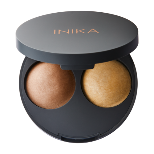 Open INIKA Organic Baked Highlight Duo compact with two baked highlighter shades in an elegant black case.
