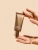 INIKA Organic Renew & Restore Peel tube held gently between hands against a clean light background.