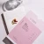 Advanced Nutrition Programme Skin Ultimate supplement set with pink packaging, capsules, folder and glass of water.